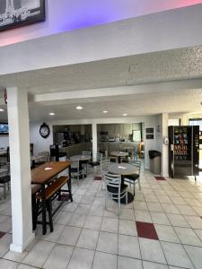 a dining room with tables and chairs in a restaurant at Super 8 by Wyndham North Platte in North Platte
