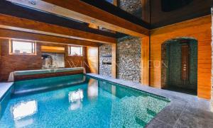 an indoor swimming pool in a house at Château De La Feuilleraie Maison de Maître in Saint-Leu-la-Forêt