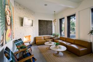 a living room with a couch and tables at SCP Seven4One Hotel in Laguna Beach