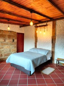 Кровать или кровати в номере Alojamiento Villa de Piedras