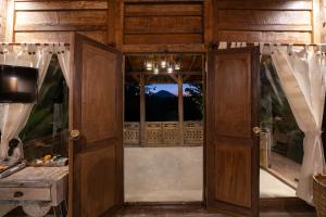 an open door to a room with a window at Umah Capung Sebatu Villas in Tegalalang