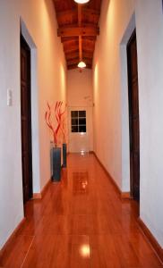 a hallway with a hard wood floor and a vase at Posada Inguz in Villa Berna