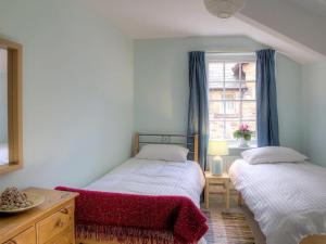 a bedroom with two beds and a window at Dorothy Forster Court in Alnwick