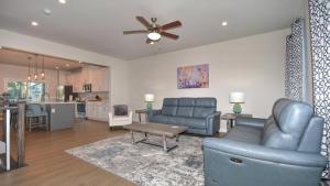 a living room with blue furniture and a kitchen at 802 Dye Townhouse home in North Myrtle Beach