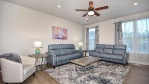 a living room with two chairs and a ceiling fan at 802 Dye Townhouse home in North Myrtle Beach