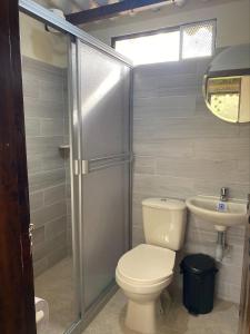 a bathroom with a toilet and a sink at MALAVI Cabaña Nobsa in Nobsa +10 photos