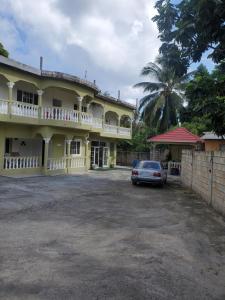 a car parked in front of a building at Comfy Guest Rooms in Port Antonio