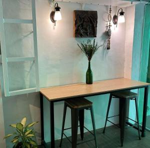 a table with a vase of flowers on it at Aden Hotel in Manila