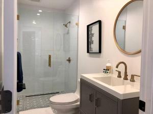a bathroom with a toilet and a sink and a mirror at Silverlake and Echo Park - 6min to Downtown and Hollywood - in Los Angeles