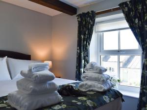 a pile of towels sitting on top of a bed at Meadow View in Youlgreave