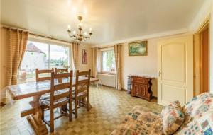 a living room with a table and a dining room at La Haie in Les Montils