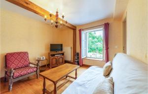 a living room with a couch a table and a tv at La Haie in Les Montils +6 photos