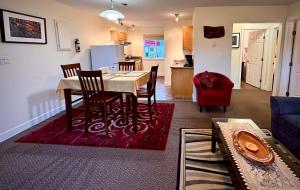 a dining room and kitchen with a table and chairs at Bayshore Waterfront Inn in Ucluelet