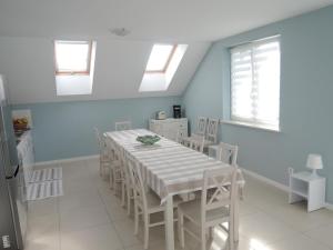 a dining room with a white table and chairs at Holiday home in Wiselka in Wisełka