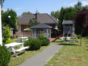 a park with picnic tables and a playground at Holiday home in Wiselka in Wisełka