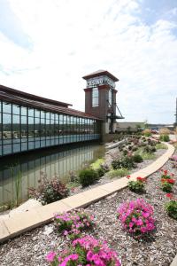 a building with flowers in front of a body of water at Fun City Resort Hotel in Burlington