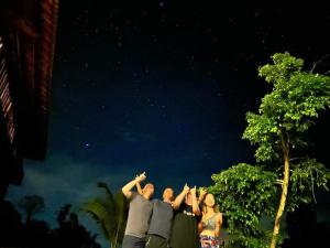 a group of people standing with their hands in the sky at Floor river view in Cat Tien