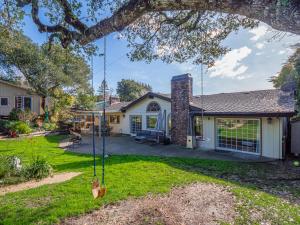 a house with a yard with a swing at Amazing Santa Cruz Landscaped Paradise in Santa Cruz