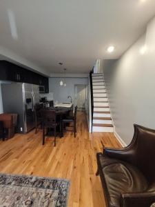 a living room with a table and chairs and a staircase at City vibes in Philadelphia