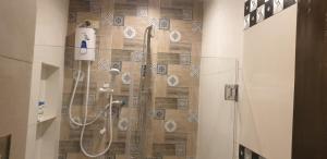 a bathroom with a shower with a shower head at Tagum Mini Hotel By Tripleview residences in Tagum