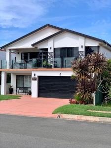 a large white house with a garage at Pelicans Rest Shellharbour in Shellharbour