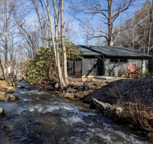 a small house with a stream in front of it at The Bungalow At Greenbriar Creek -Pickleball Court, Creek, WIFI, Mountain Views, Starting at 79" in Cosby