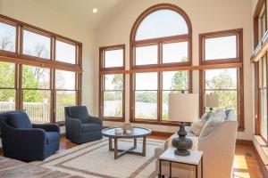a living room with a lot of windows at River Haven with Hot Tub in Delta