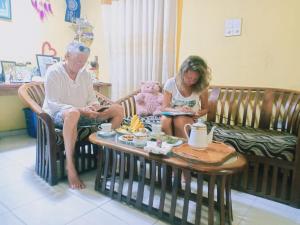 an older woman and a girl sitting on a couch at Walampuri Cabana & Restaurant in Tangalle