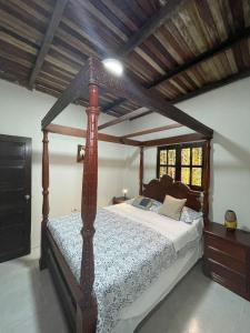 a bedroom with a wooden canopy bed in a room at Amazon Lodge Varillal in Iquitos
