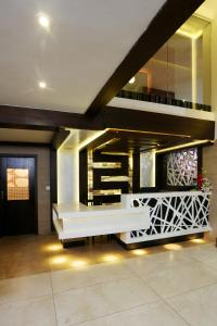 a lobby with a white bench in a building at moriz inn in Mysore