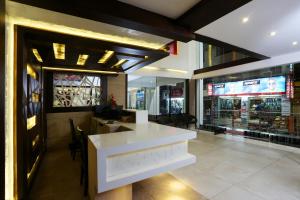 a restaurant with a white counter in front of a store at moriz inz in Mysore