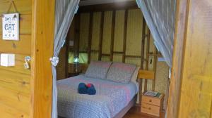 a bedroom with a bed with shoes on it at la Cabane de la Vallee in Dumbéa