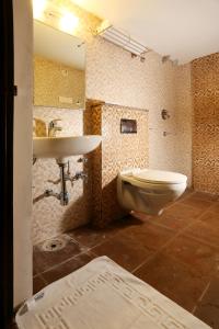 a bathroom with a sink and a toilet at moriz inn in Mysore