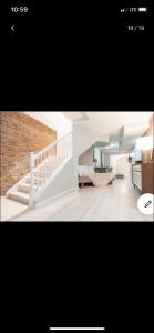 een foto van een woonkamer met een trap bij Jersey city abode mins to city in Jersey City