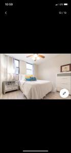 a bedroom with a bed and a ceiling fan at Jersey city abode mins to city in Jersey City