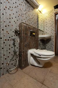 a bathroom with a toilet and a sink at moriz inn in Mysore