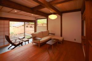 a living room with a couch and a table at Syoubun in Minakami