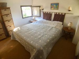 a bedroom with a bed and two lamps and a window at Maison Porto-Vecchio, 3 pièces, 6 personnes - FR-1-62-152 in Porto-Vecchio