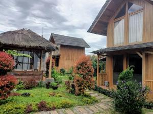 a house with a garden in front of it at ADK Papandayan Homestay & Tour in Tjisurupan