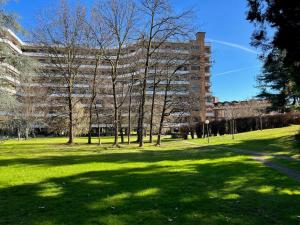 a park with trees and a large building at Milano San Siro Club in Milan