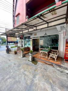 a store front with a ping pong table on a patio at Ratanawong Place 403 in Bangkok