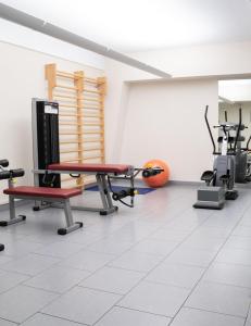 a gym with treadmills and exercise equipment in a room at Hotel Pergola in Legnago