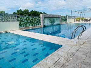 a swimming pool with blue tiles on a building at Wafa Hotel & Apartment in Kampong Mata Mata
