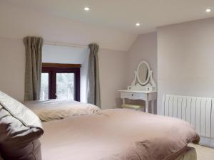 a bedroom with two beds and a mirror on the wall at Southview in Porchfield