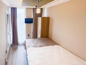 Ein Bett oder Betten in einem Zimmer der Unterkunft Helen Inn