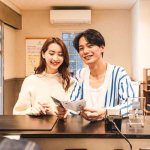 a man and a woman sitting at a table at HOTEL RELIEF Namba Daikokuchou in Osaka