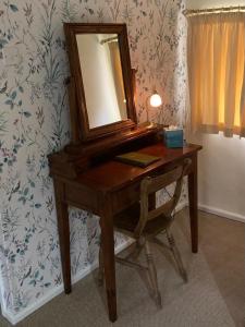 a dressing table with a mirror on top of it at Ty Mawr Country Hotel in Carmarthen