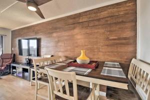 a dining room with a wooden wall with a table and chairs at Coastal Escape Penthouse with Ocean Views in Myrtle Beach