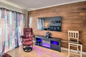 a living room with a tv on a wooden wall at Coastal Escape Penthouse with Ocean Views in Myrtle Beach