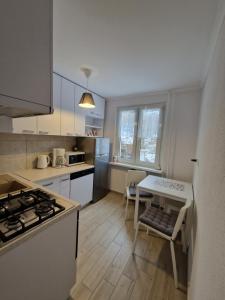 a kitchen with a table and a stove top oven at Apartament Górska Panorama in Szklarska Poręba